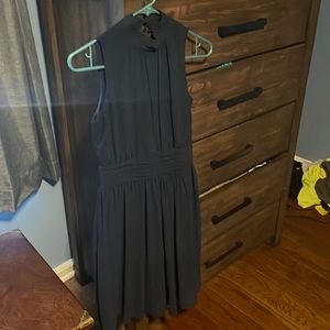 High neck navy blue dress with fitted waist.